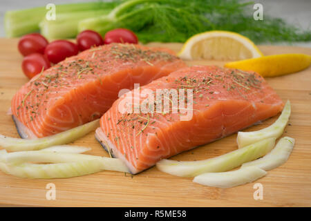 Salmon and Vegetables on a Cutting Board Stock Photo