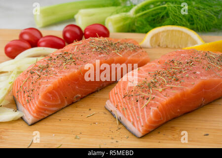 Salmon and Vegetables on a Cutting Board Stock Photo