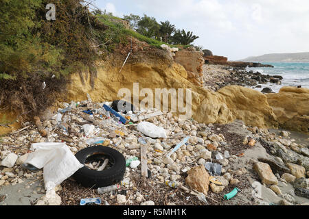 Litter and old tires on the sea shore Stock Photo