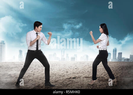 Business man and woman fighting Stock Photo