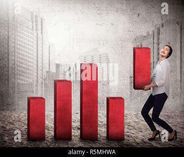 Asian business woman lifting block of chart Stock Photo