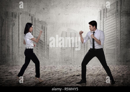 Business man and woman fighting Stock Photo