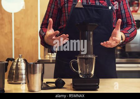 Barista brewing aeropress coffee Stock Photo