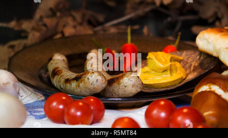Bavarian White And Red Sausages With Mustard, Bavarian Buns and Pretzels At The Table. October Fest Concept Stock Photo