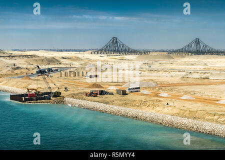 view from the newly opened extension channel of the suez canal to the el ferdan bridge and the remaining construction work on the canal Stock Photo