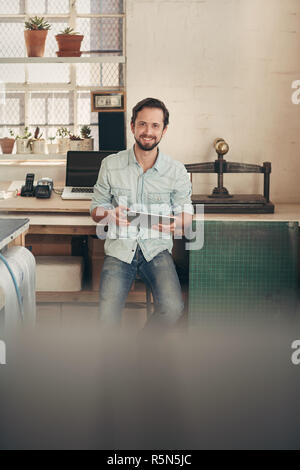 Designer businessman in his studio using a digital tablet Stock Photo