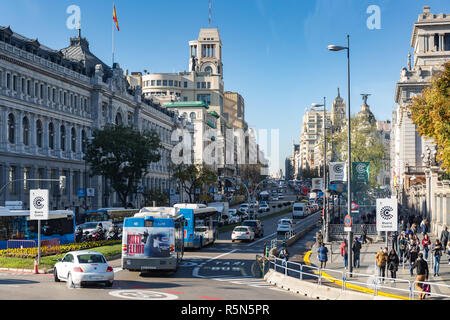 Madrid, Spain - November 29, 2018: Rush-hour on the Calle de Acala traffic circle Paseo del Prado, with cars, buses, pedestrians and motorbikes. Stock Photo