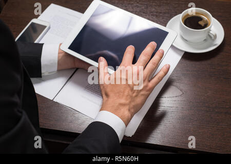 Businessman using digital tablet with charts for planning and analysis of business models, startup. Business Finance and money concept, the concept of investment Stock Photo