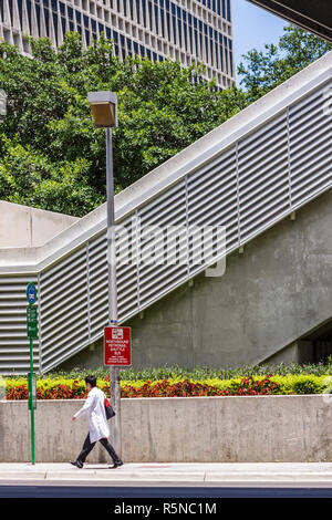 Miami Florida,NW 12th Avenue,Jackson Memorial Hospital,healthcare,Asian man men male adult adults,walking,medical worker,workers,lab coat,bus stop,bui Stock Photo