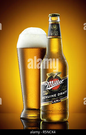 Miller beer bottle and frosty glass full of beer with foam. Stock Photo