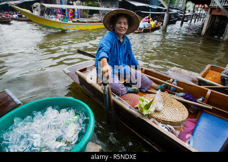 Woven hat seller at the Damnoen Saduak Floating Market on the Mae Klong River in Thailand, Southeast Asia. Stock Photo