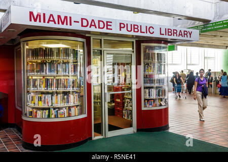 Miami Florida,Metrorail,mass transit,Civic Center Station,Miami Dade Public Library,kiosk,convenience,commuter service,reading,book,books,Hispanic wom Stock Photo