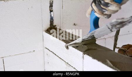 Levelling a mortar with a trowel Stock Photo