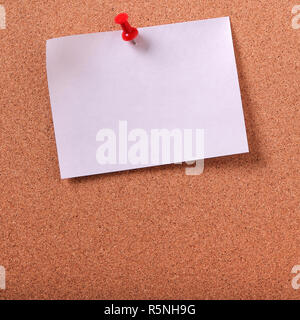One white sticky post note pinned cork bulletin board copy space Stock Photo