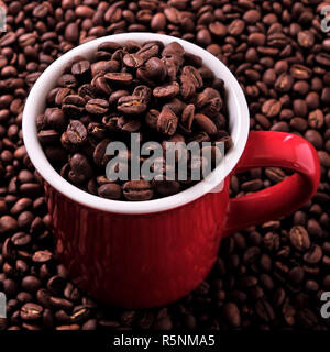 Red coffee mug filled with beans Stock Photo