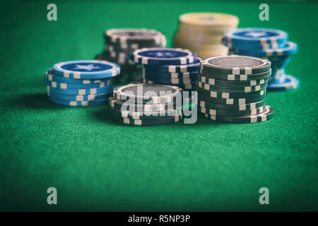 Casino, gambling concept. Poker chips piles on green felt background, copy space Stock Photo