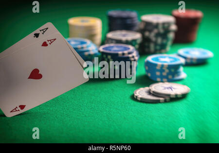 Casino, gambling concept. Two aces and poker chips on green felt background Stock Photo
