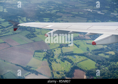 Window view of flying over the British countryside close to London, United Kingdom Stock Photo