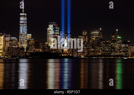 9/11 Memorial Beams with Statue of Liberty and Lower Manhattan Stock Photo