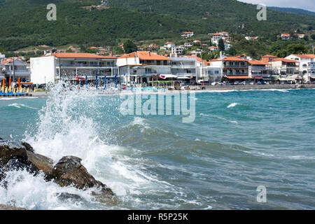 Waves breaking onto a stony seashore. Close-up. Stock Photo