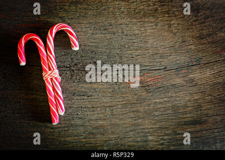 Christmas candy canes on a wooden background with copy space Stock Photo