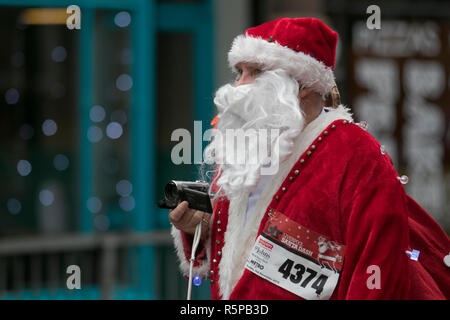 Liverpool, Merseyside, UK.  2nd November, 2018. BTR Liverpool Santa Dash.  People across Merseyside celebrate the  return of the UK’s biggest festive 5K fun run. The festive event has  continued to grow  with up to 10,000 runners, red, blue Santas taking part this year.  The route took the Dashing Santas through the city centre, before they crossed the finish line outside Town Hall, where they were greeted by myriad of festive characters. Credit:MediaWorldImages/AlamyLiveNews. Stock Photo