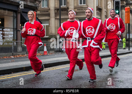 Liverpool, Merseyside, UK.  2nd November, 2018. BTR Liverpool Santa Dash.  People across Merseyside celebrate the  return of the UK’s biggest festive 5K fun run. The festive event has  continued to grow  with up to 10,000 runners, red, blue Santas taking part this year.  The route took the Dashing Santas through the city centre, before they crossed the finish line outside Town Hall, where they were greeted by myriad of festive characters. Credit:MediaWorldImages/AlamyLiveNews. Stock Photo