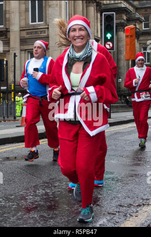 Liverpool, Merseyside, UK.  2nd November, 2018. BTR Liverpool Santa Dash.  People across Merseyside celebrate the  return of the UK’s biggest festive 5K fun run. The festive event has  continued to grow  with up to 10,000 runners, red, blue Santas taking part this year.  The route took the Dashing Santas through the city centre, before they crossed the finish line outside Town Hall, where they were greeted by myriad of festive characters. Credit:MediaWorldImages/AlamyLiveNews. Stock Photo