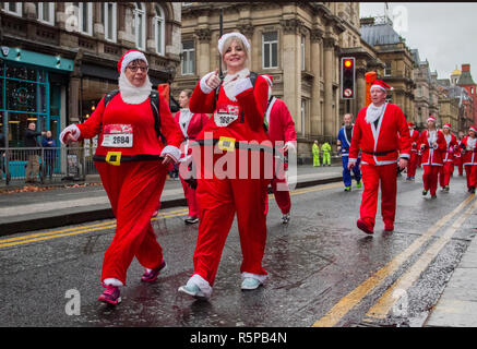 Liverpool, Merseyside, UK.  2nd November, 2018. BTR Liverpool Santa Dash.  People across Merseyside celebrate the  return of the UK’s biggest festive 5K fun run. The festive event has  continued to grow  with up to 10,000 runners, red, blue Santas taking part this year.  The route took the Dashing Santas through the city centre, before they crossed the finish line outside Town Hall, where they were greeted by myriad of festive characters. Credit:MediaWorldImages/AlamyLiveNews. Stock Photo