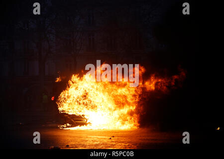 Paris, France.  1st December 2018.  . Demonstrators light a car  on fire during a protest of the yellow jackets. Credit: ALEXANDROS MICHAILIDIS/Alamy Live News Stock Photo