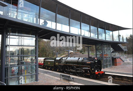 Shropshire, UK. 2nd Dec 2018. Old meets new! Britannia steam locomotive arriving at Telford Central Railway Station under the new footbridge which opened this week. The locomotive was built in 1952 at cost of £20,325 and the bridge which also spans the adjacent road cost £10 million. Today the locomotive was pulling the Welsh Borders Christmas Explorer. Credit: David Bagnall/Alamy Live News Stock Photo