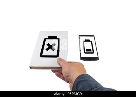 Hand taking a book instead of phone. New versus old concept. Low battery problem. Stock Photo