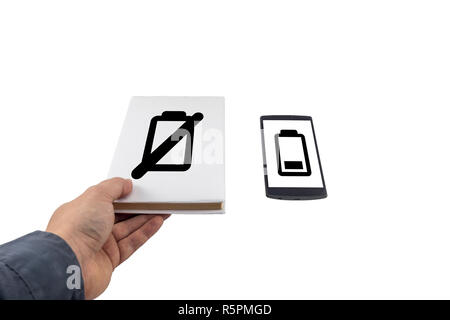 Hand taking a book instead of phone. New versus old concept. Low battery problem. Stock Photo