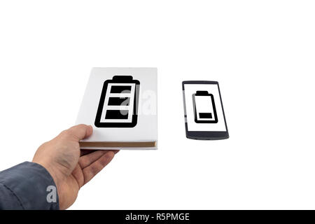 Hand taking a book instead of phone. New versus old concept. Low battery problem. Stock Photo