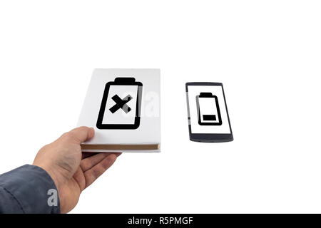 Hand taking a book instead of phone. New versus old concept. Low battery problem. Stock Photo