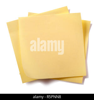 Untidy stack yellow sticky post notes isolated on white Stock Photo