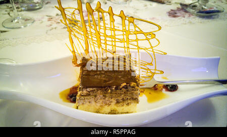 Tiramisu cake decorated with artistic crispy caramel. Stock Photo