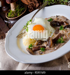 forest mushroom sauce with fresh mushrooms,potato and poached egg Stock Photo