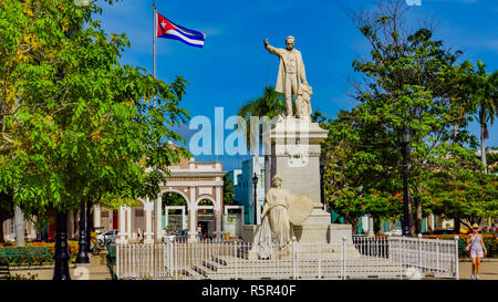 CIENFUEGOS, CUBA - MAY 25, 2014: Unidentified people by statue of Jose Marti in Cienfuegos, Cuba. Statue statue of Jose Marti was added in Marti Park  Stock Photo