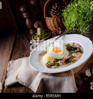 forest mushroom sauce with fresh mushrooms,potato and poached egg Stock Photo