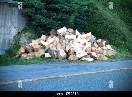 A large pile of wood that has been cut and split into firewood to be used as fuel for heating in fireplaces and furnaces in the cold winter months. A  Stock Photo