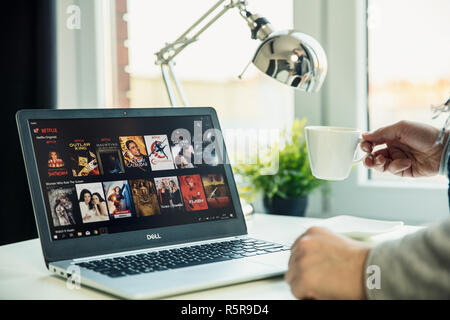 WROCLAW, POLAND - NOVEMBER 29th, 2018: Modern laptop on the desk in office with Netflix application on the screen. Netflix is an American that primary Stock Photo