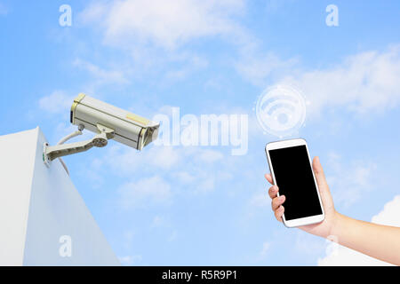 phone and security camera on building with blue sky, internet and WiFi connected Stock Photo