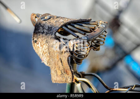 Close-up photography. The old bicycle seat is damaged. Stock Photo