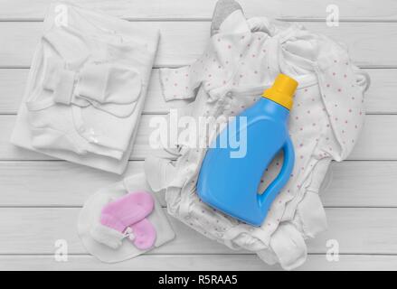 Care for children's clothes. Gentle detergent. Emphasis on the bottle. Stock Photo