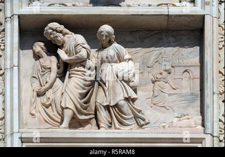 Lot and his daughters flee from Sodom, marble relief on the facade of the Milan Cathedral , Duomo di Santa Maria Nascente, Milan, Lombardy, Italy Stock Photo