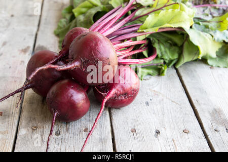 Red Beetroot with herbage green leaves on rustic background. Organic Beetroot Stock Photo