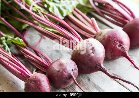 Red Beetroot with herbage green leaves on rustic background. Organic Beetroot Stock Photo