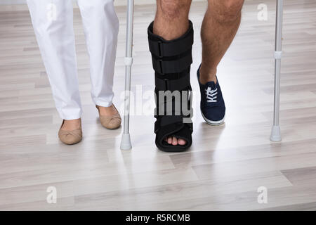 Low Section View Of Physiotherapist And Injured Person's Leg Stock Photo