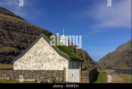 Small white church with a grass roof at Saksun in the north of the Faroe Islands Stock Photo